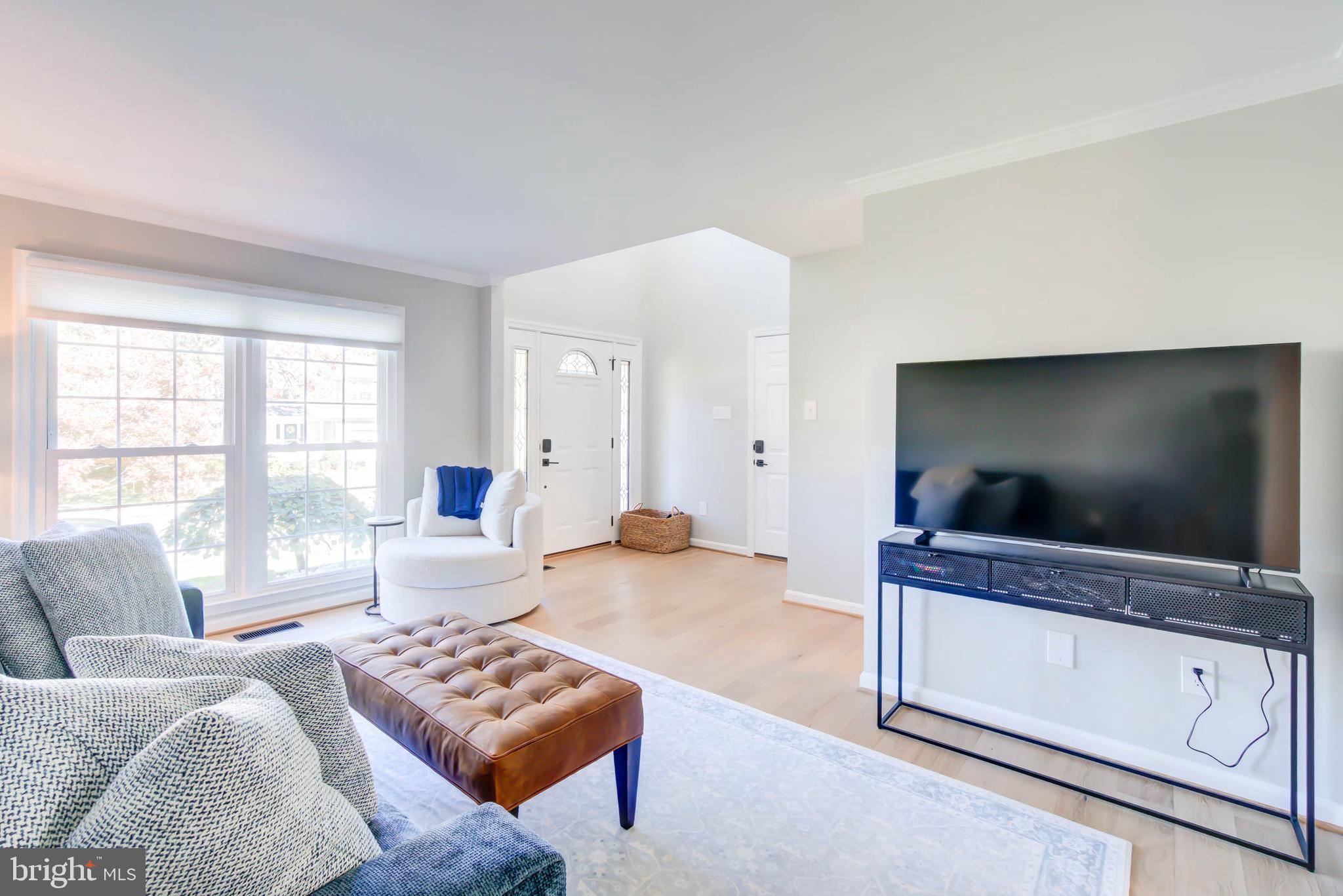 6617 Morning Ride Circle Alexandria, VA 22315 - Photo 10 of 51 a living room with furniture and a flat screen tv