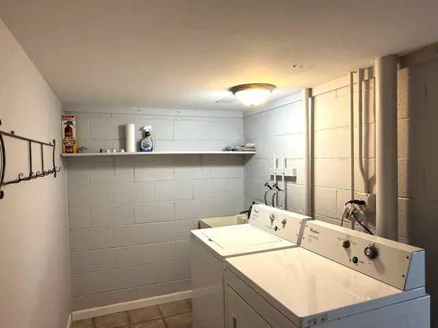 a room with a sink cabinets and wooden floor