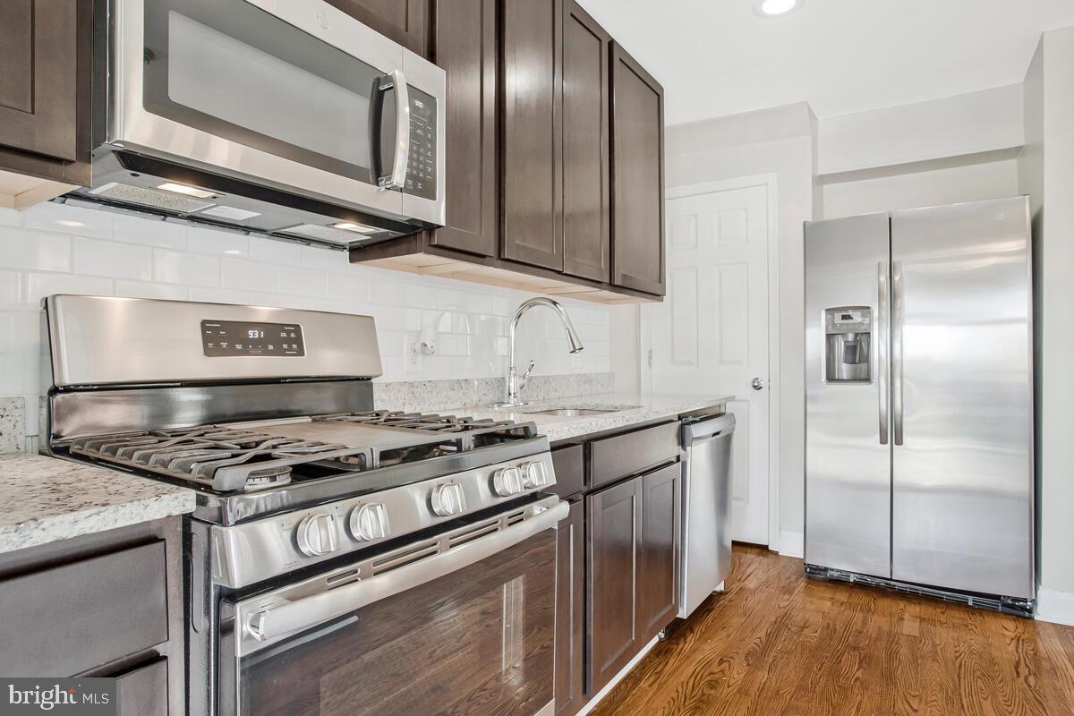 8352 Kavanagh Road Dundalk, MD 21222 - Photo 14 of 32 a kitchen with stainless steel appliances granite countertop a stove and a refrigerator