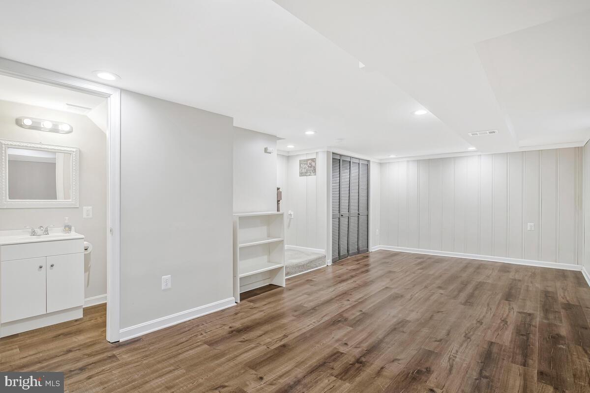8352 Kavanagh Road Dundalk, MD 21222 - Photo 24 of 32 a view of an empty room with wooden floor and a bathroom
