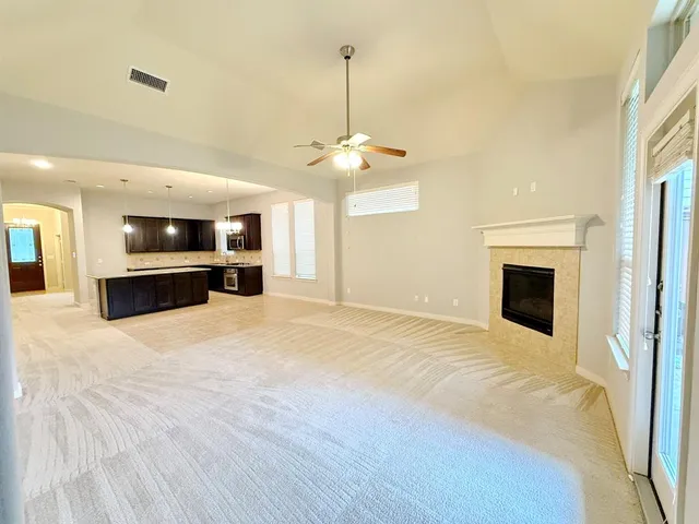 a view of a livingroom with a fireplace a sink and dishwasher kitchen view
