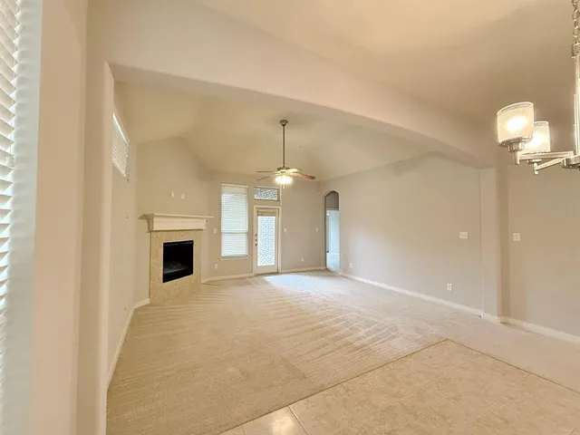 a view of empty room with a fireplace