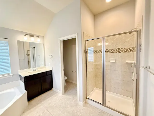 a bathroom with a glass door shower sink and mirror