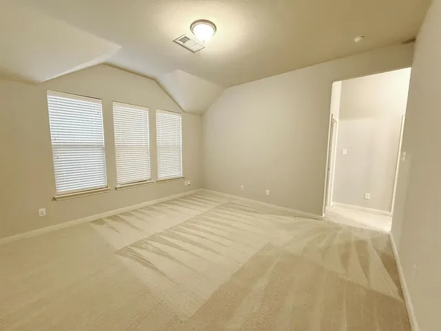an empty room with windows and closet