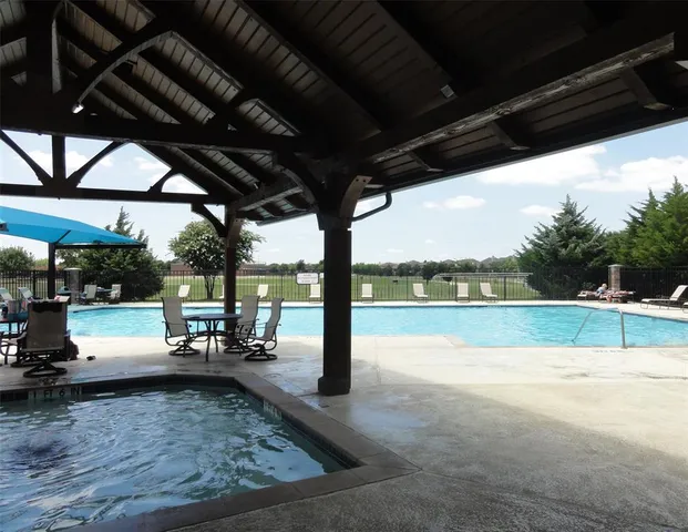 a view of a swimming pool with a patio