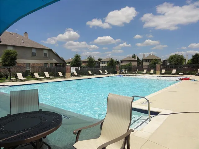 a view of a chairs and table in patio