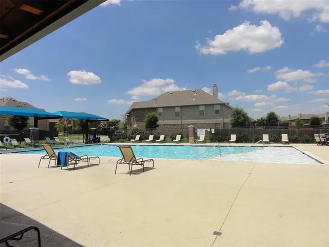 a view of a swimming pool with a lounge chair