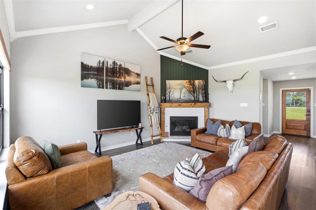 2990 Wilson Road Palmer, TX 75152 - Photo 11 of 40 a living room with furniture a fireplace and a flat screen tv