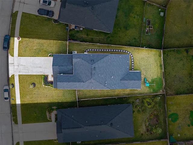 an aerial view of a house with a yard