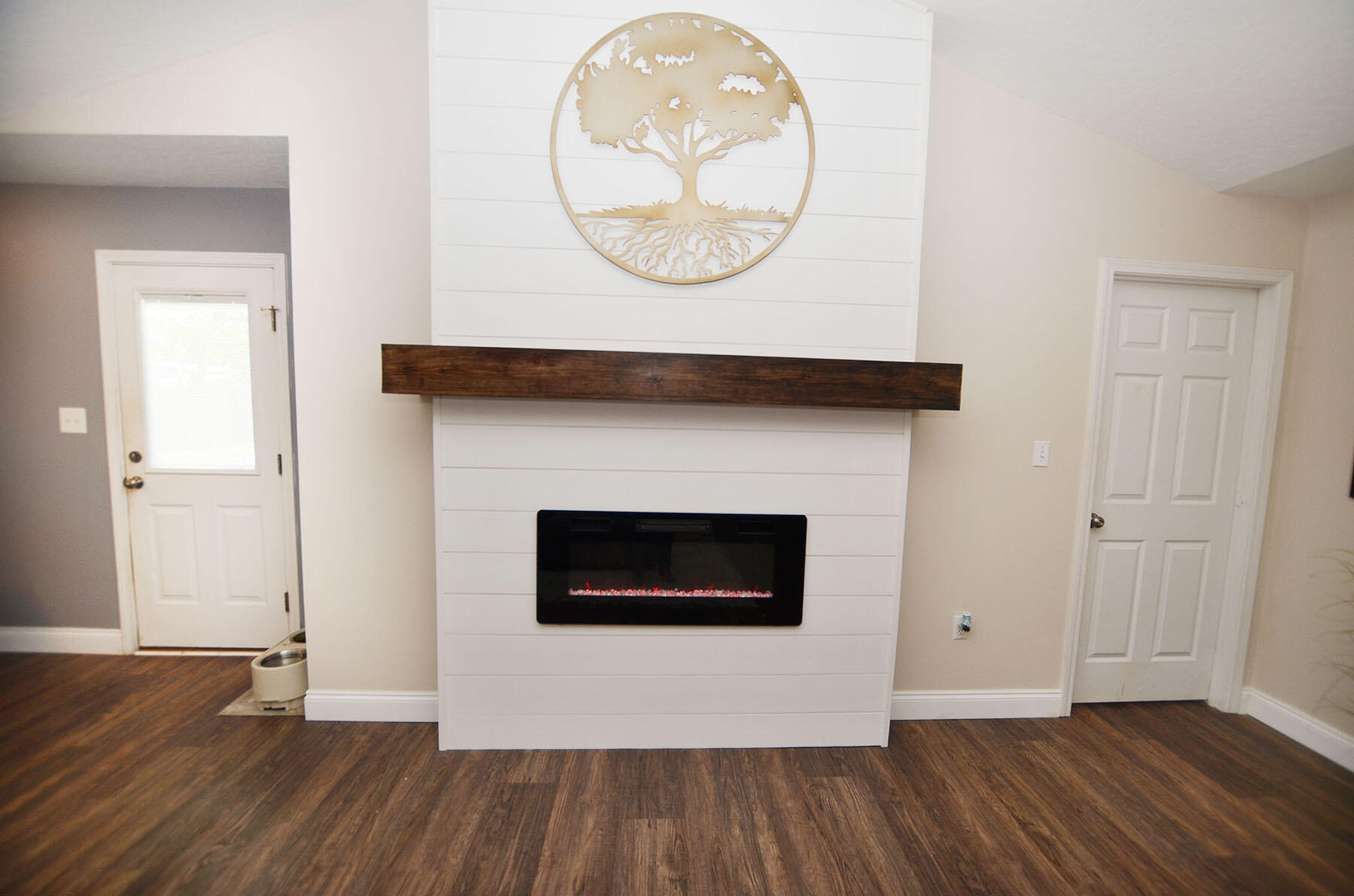 8271 Tavira Street Navarre, FL 32566 - Photo 11 of 60 a view of a livingroom with wooden floor and a fireplace