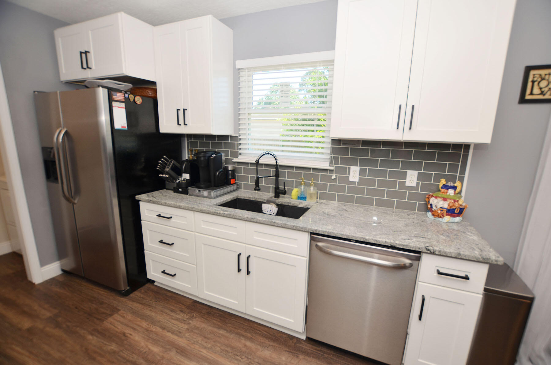 8271 Tavira Street Navarre, FL 32566 - Photo 16 of 60 a kitchen with stainless steel appliances granite countertop a refrigerator sink and stove