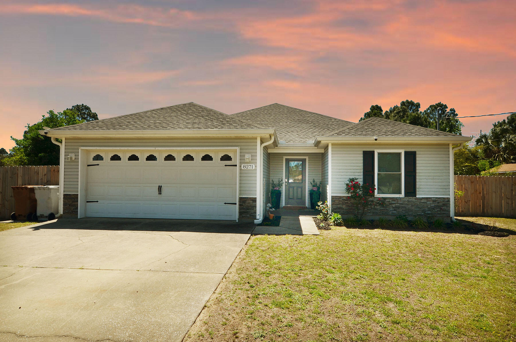8271 Tavira Street Navarre, FL 32566 - Photo 2 of 60 a front view of a house with a yard