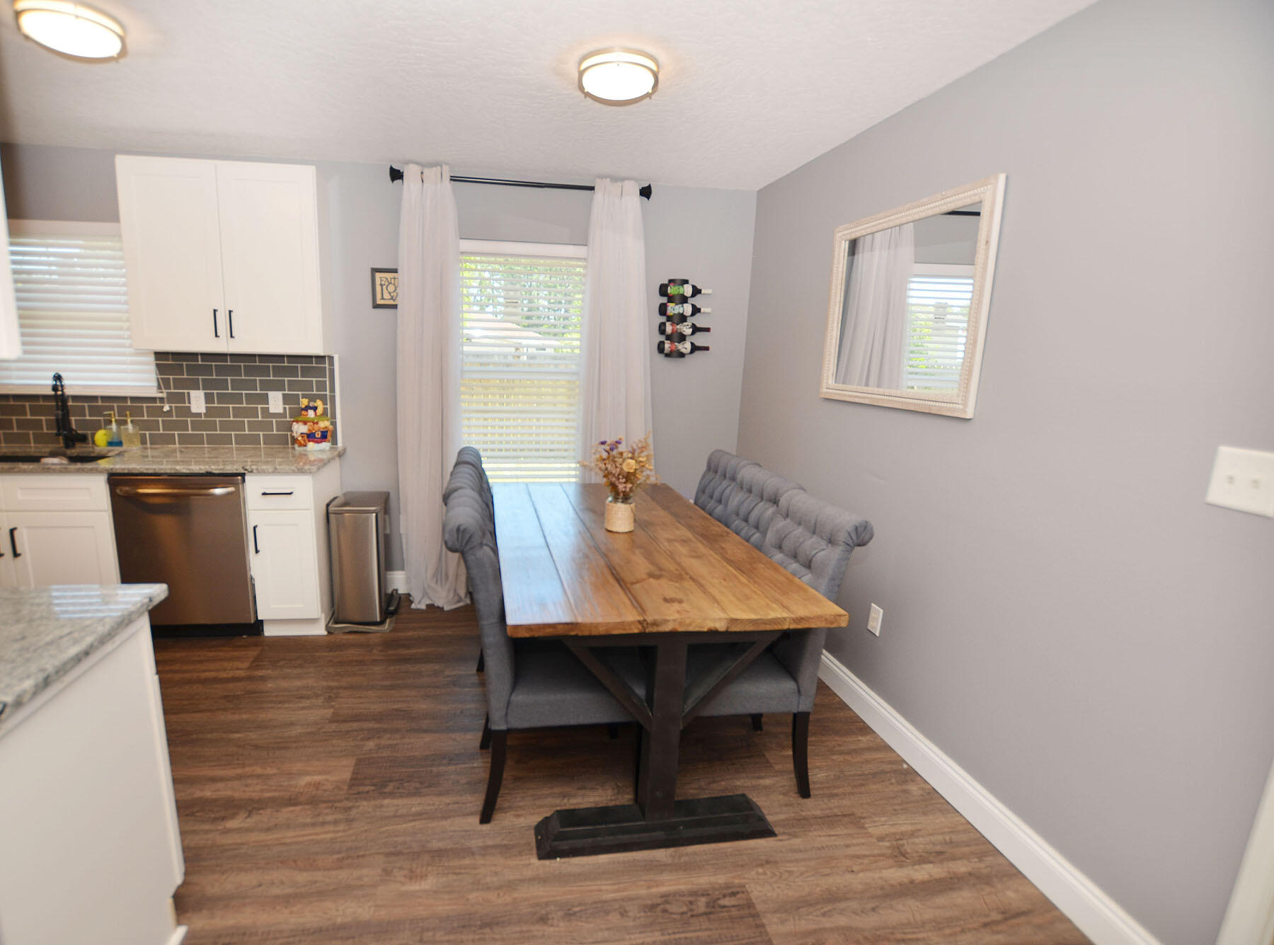 8271 Tavira Street Navarre, FL 32566 - Photo 24 of 60 a view of a dining room with furniture and wooden floor