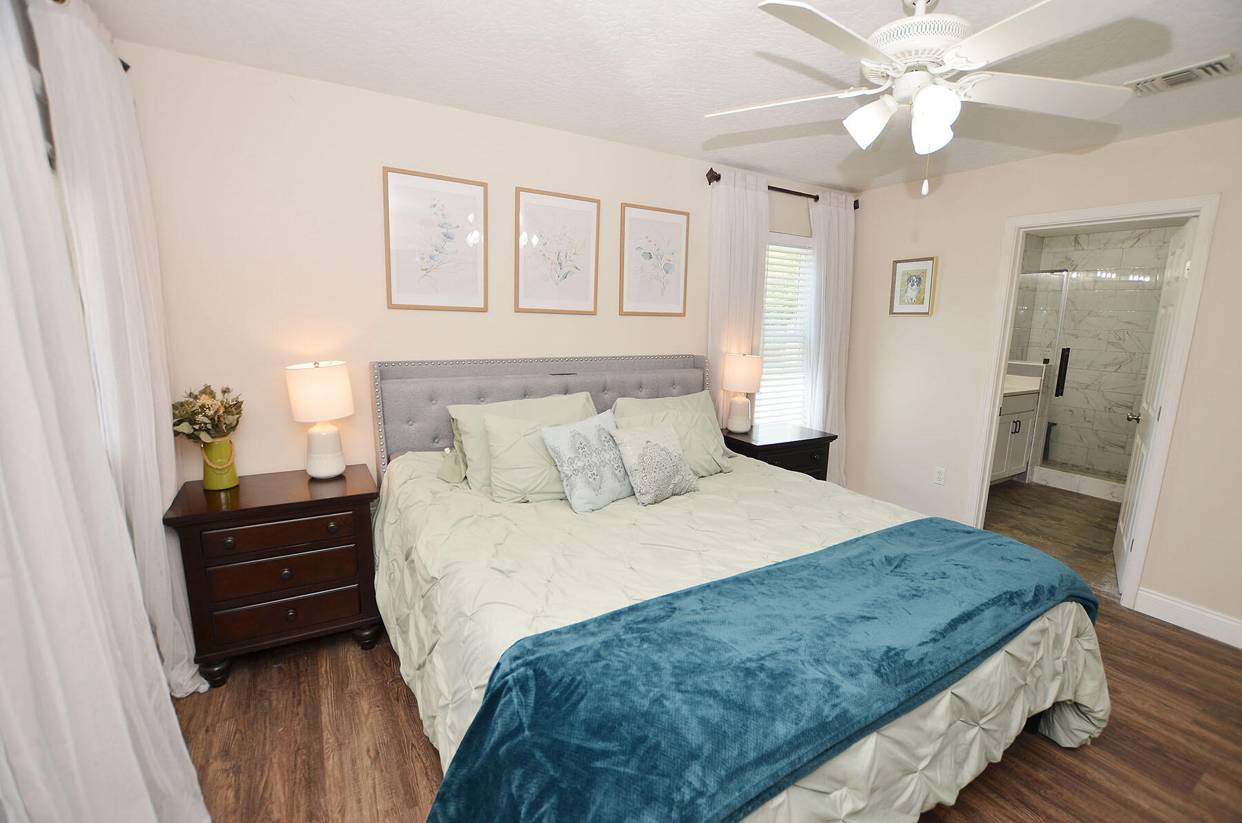 8271 Tavira Street Navarre, FL 32566 - Photo 28 of 60 a bedroom with a bed and a chandelier
