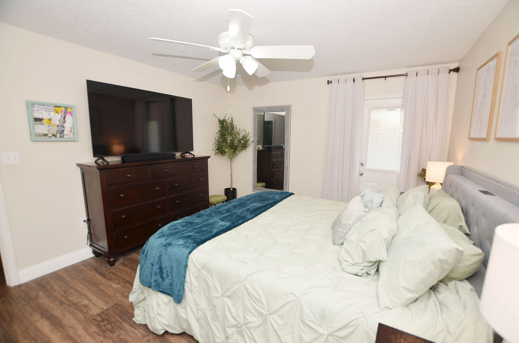 8271 Tavira Street Navarre, FL 32566 - Photo 29 of 60 a bedroom with a bed and a flat screen tv