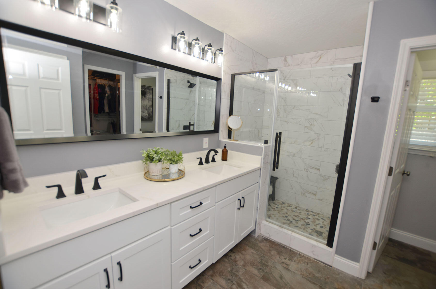 8271 Tavira Street Navarre, FL 32566 - Photo 30 of 60 a bathroom with a double vanity sink and mirror
