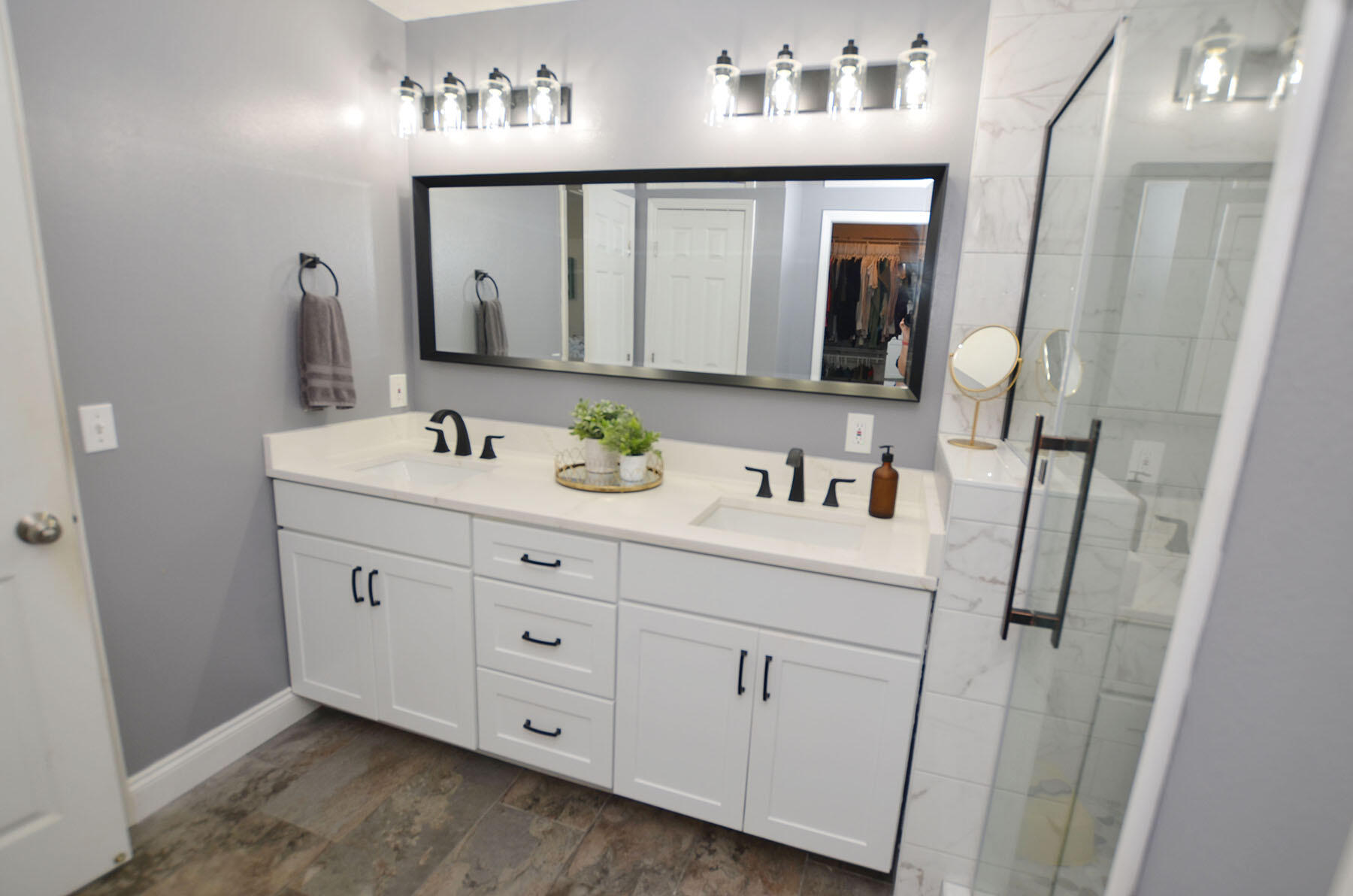 8271 Tavira Street Navarre, FL 32566 - Photo 32 of 60 a bathroom with a double vanity sink mirror and toilet
