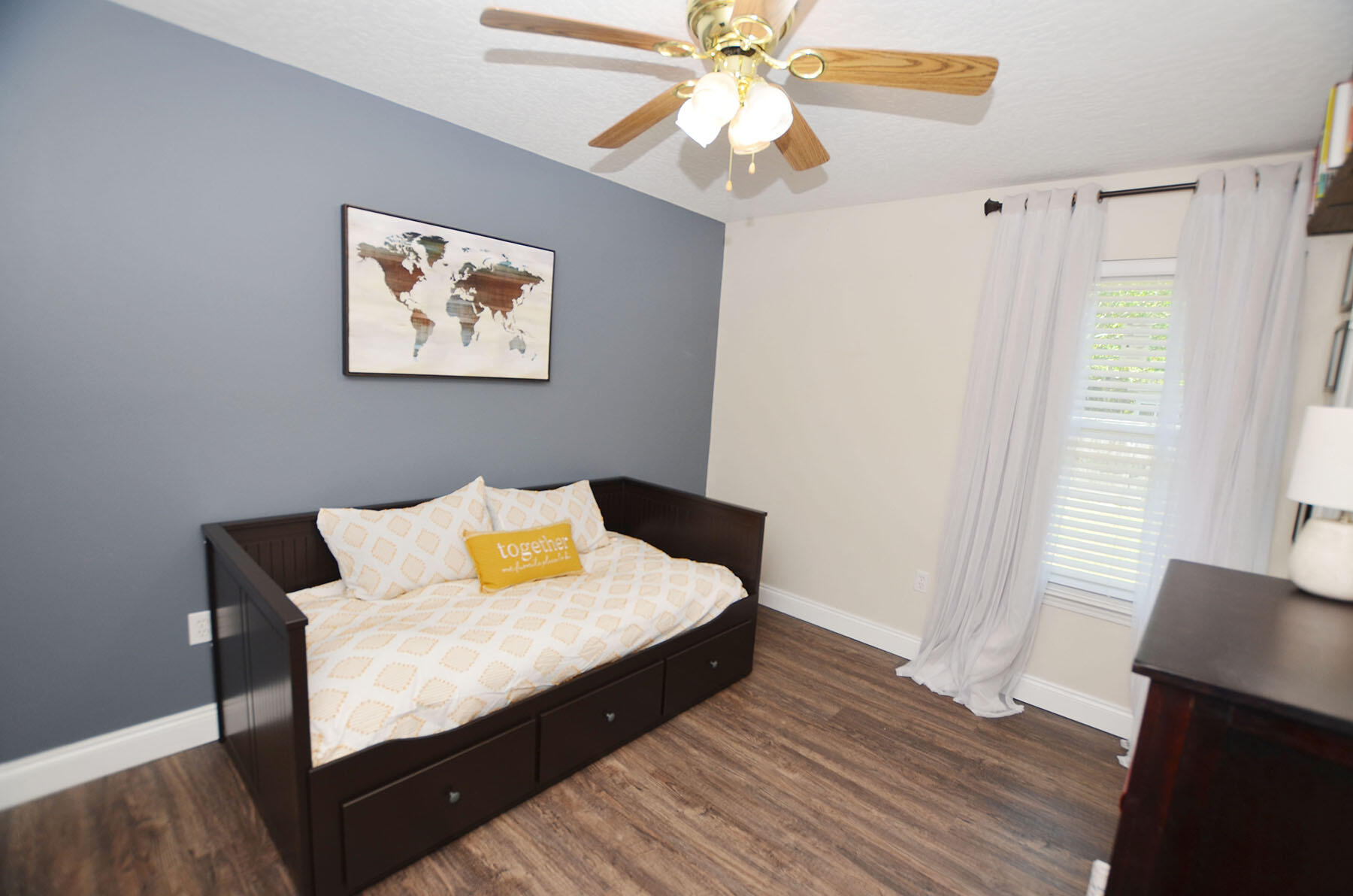 8271 Tavira Street Navarre, FL 32566 - Photo 41 of 60 a bedroom with a bed and wooden floor