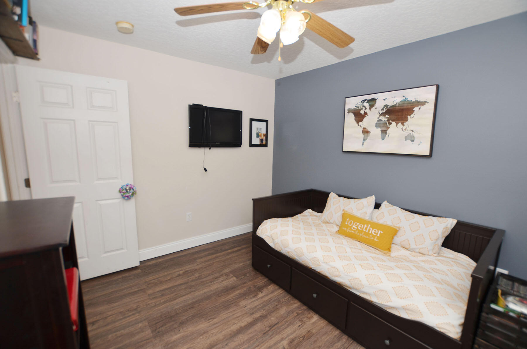 8271 Tavira Street Navarre, FL 32566 - Photo 43 of 60 a bedroom with a bed and a flat screen tv