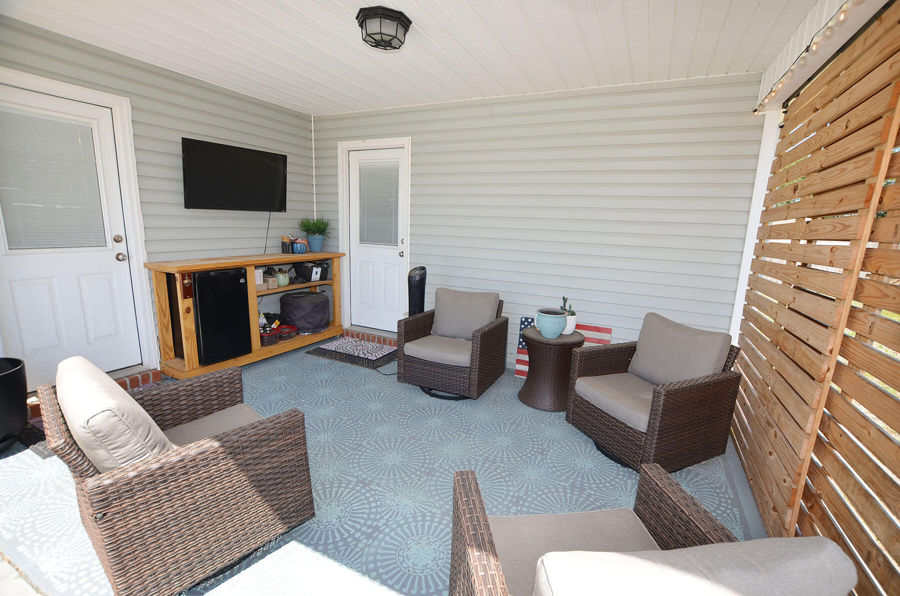 8271 Tavira Street Navarre, FL 32566 - Photo 54 of 60 a living room with furniture and a flat screen tv