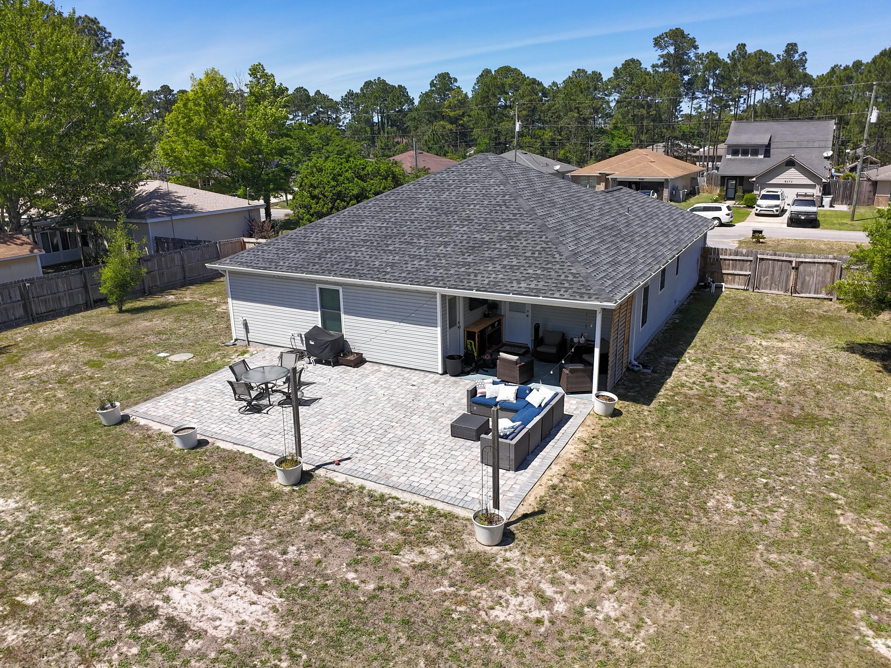 8271 Tavira Street Navarre, FL 32566 - Photo 58 of 60 a view of a house with backyard porch and sitting area