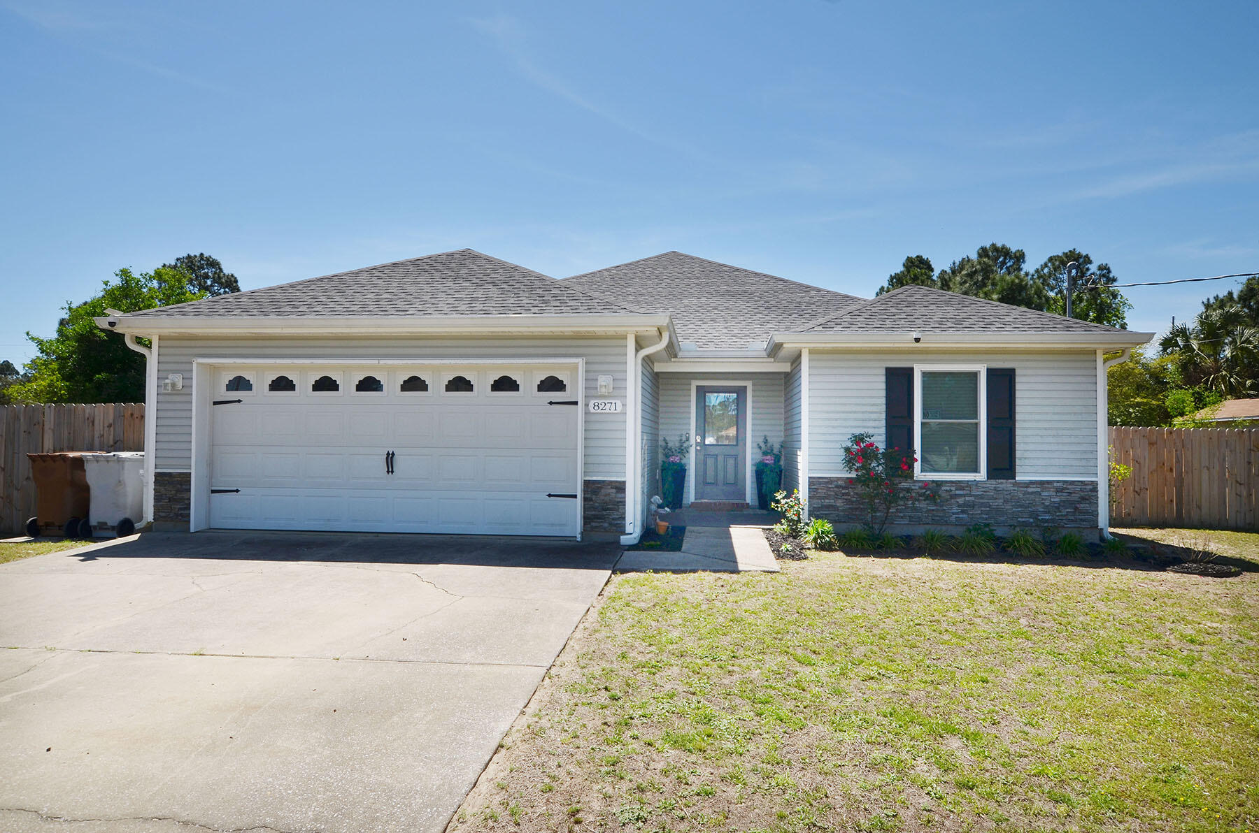 8271 Tavira Street Navarre, FL 32566 - Photo 60 of 60 a front view of a house with a yard