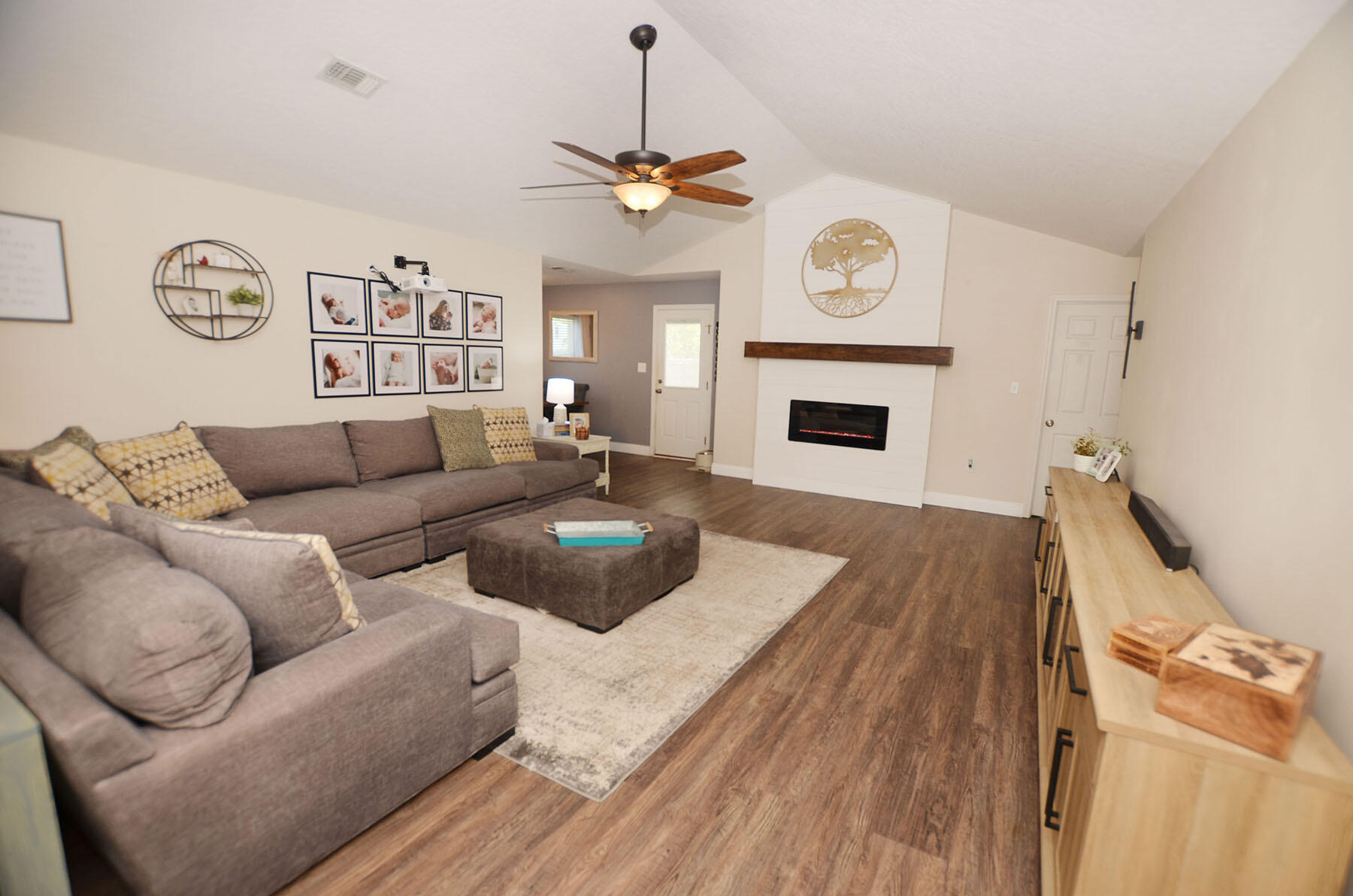 8271 Tavira Street Navarre, FL 32566 - Photo 8 of 60 a living room with furniture a fireplace and window