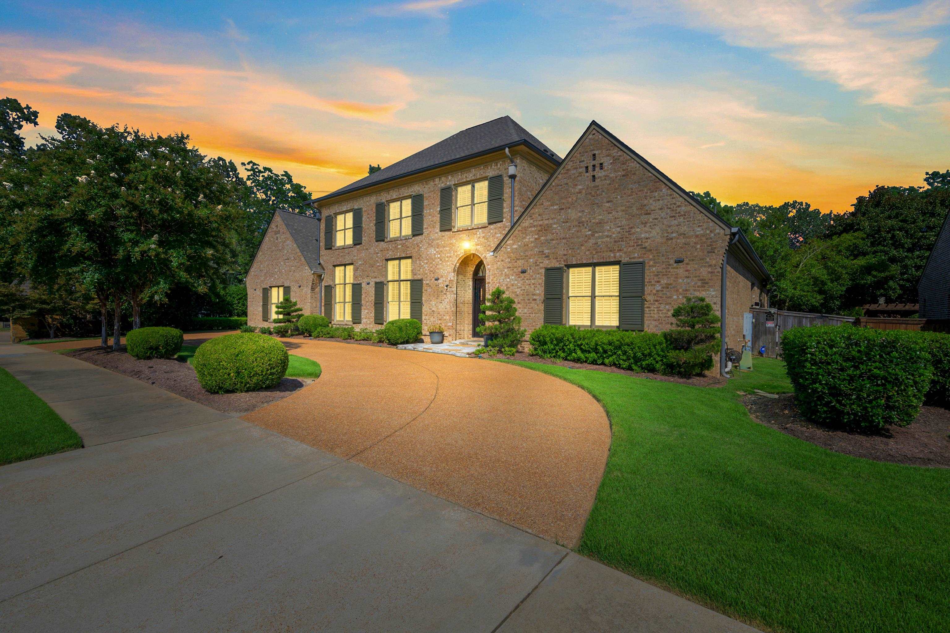 2840 Rue Jordan Cove Germantown, TN 38138 - Photo 2 of 40 a front view of a house with a yard and garage