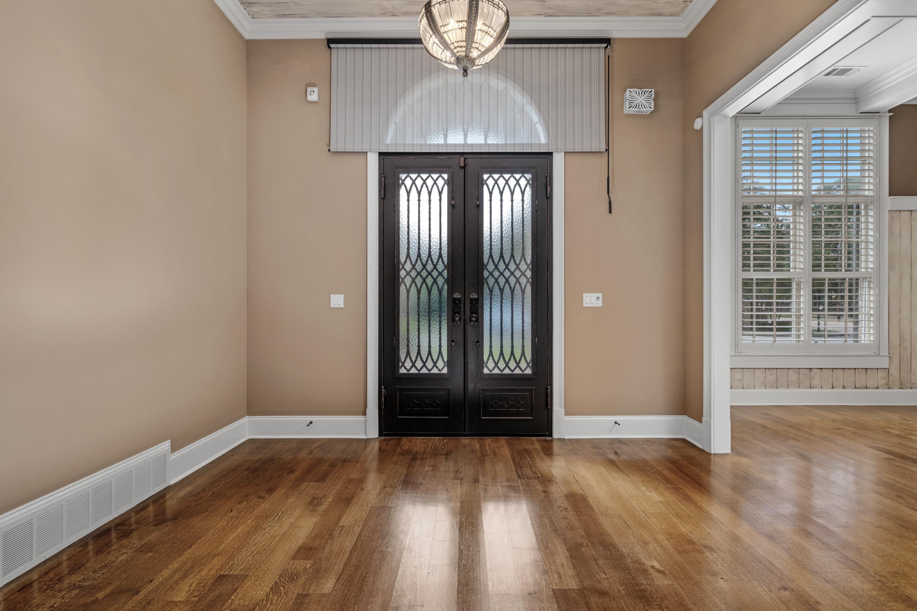 2840 Rue Jordan Cove Germantown, TN 38138 - Photo 5 of 40 an empty room with wooden floor chandelier and windows