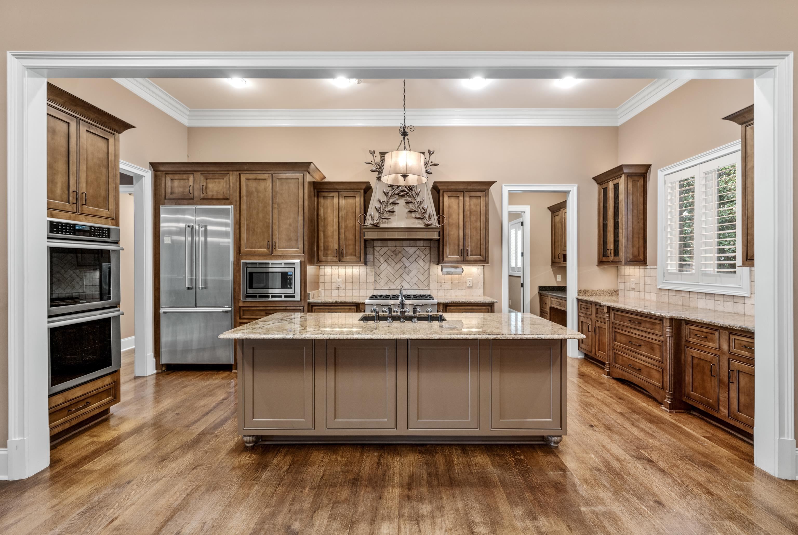2840 Rue Jordan Cove Germantown, TN 38138 - Photo 10 of 40 a kitchen with stainless steel appliances granite countertop a stove and cabinets