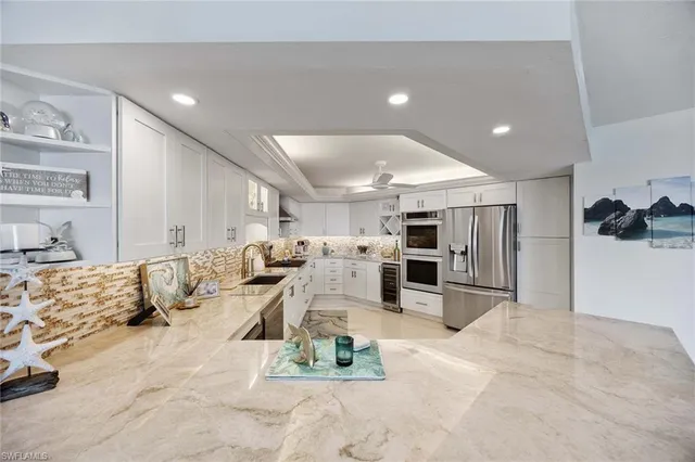 a kitchen with stainless steel appliances granite countertop a sink and dishwasher