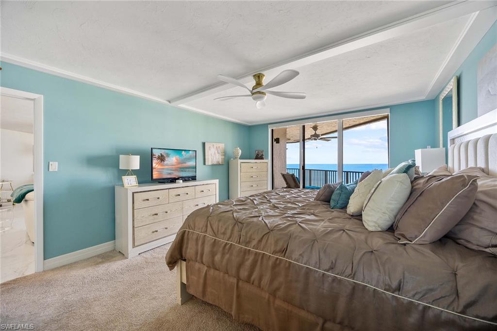 840 South Collier Boulevard, Unit 1104 Marco Island, FL 34145 - Photo 20 of 50 a bedroom with a large bed and a chandelier