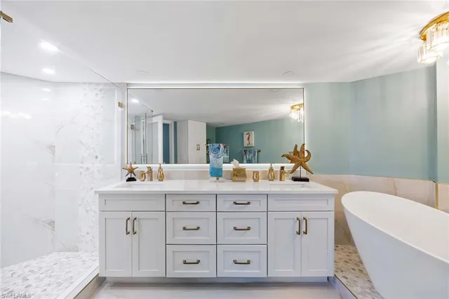 a spacious bathroom with a bathtub and sink