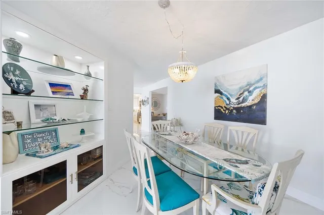 a view of a dining room with furniture and chandelier