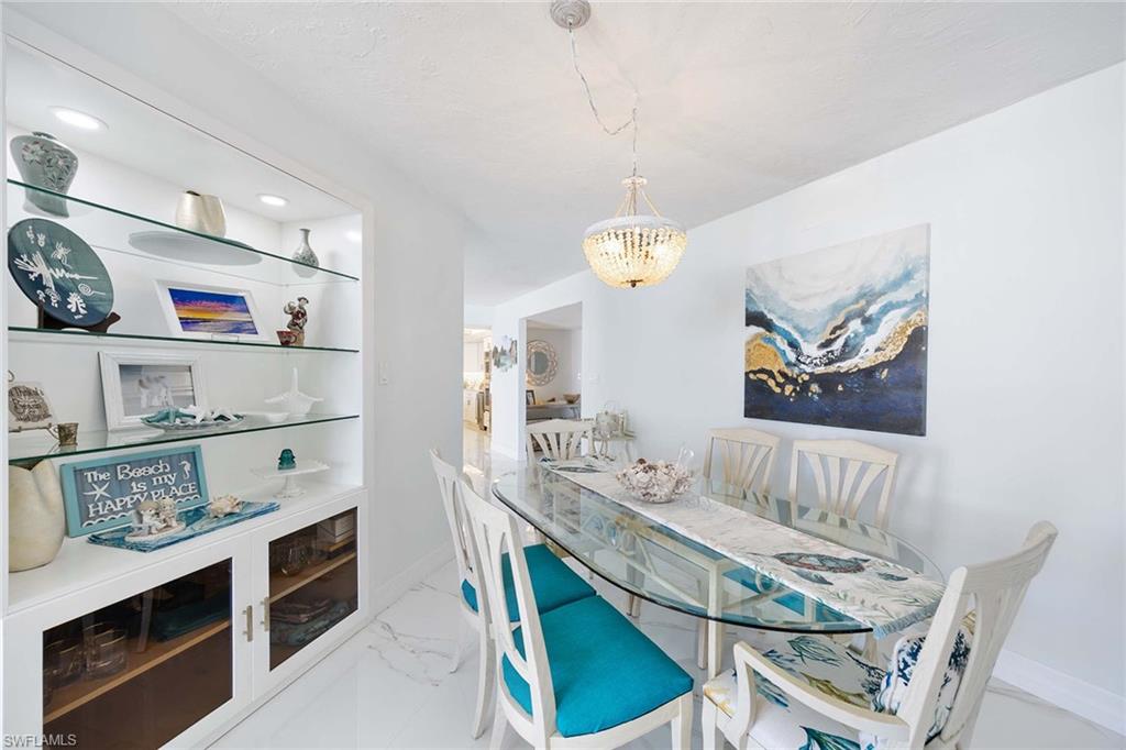 840 South Collier Boulevard, Unit 1104 Marco Island, FL 34145 - Photo 24 of 50 a dining room with furniture and wooden floor