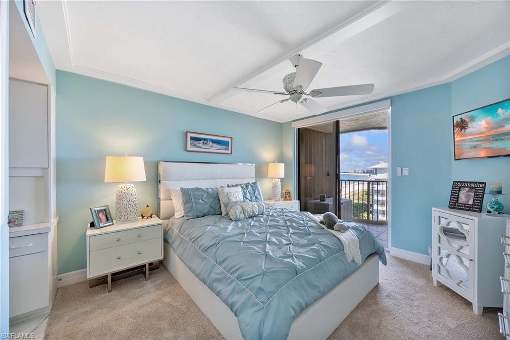 840 South Collier Boulevard, Unit 1104 Marco Island, FL 34145 - Photo 26 of 50 a bedroom with a large bed and a chandelier