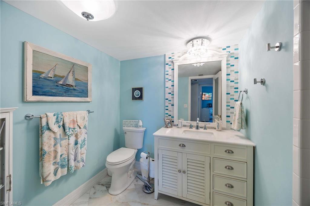 840 South Collier Boulevard, Unit 1104 Marco Island, FL 34145 - Photo 28 of 50 a bathroom with a double vanity sink mirror and toilet