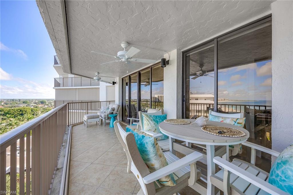 840 South Collier Boulevard, Unit 1104 Marco Island, FL 34145 - Photo 32 of 50 a view of a balcony dining table and chairs
