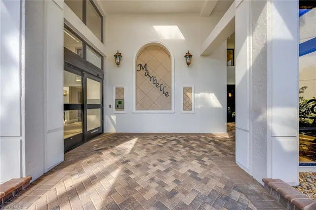a building outdoor space with couches and potted plants