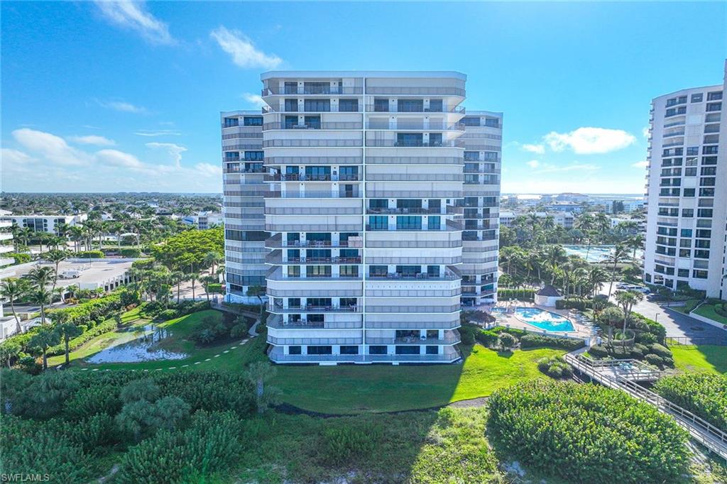 840 South Collier Boulevard, Unit 1104 Marco Island, FL 34145 - Photo 44 of 50 a view of a large building with a yard
