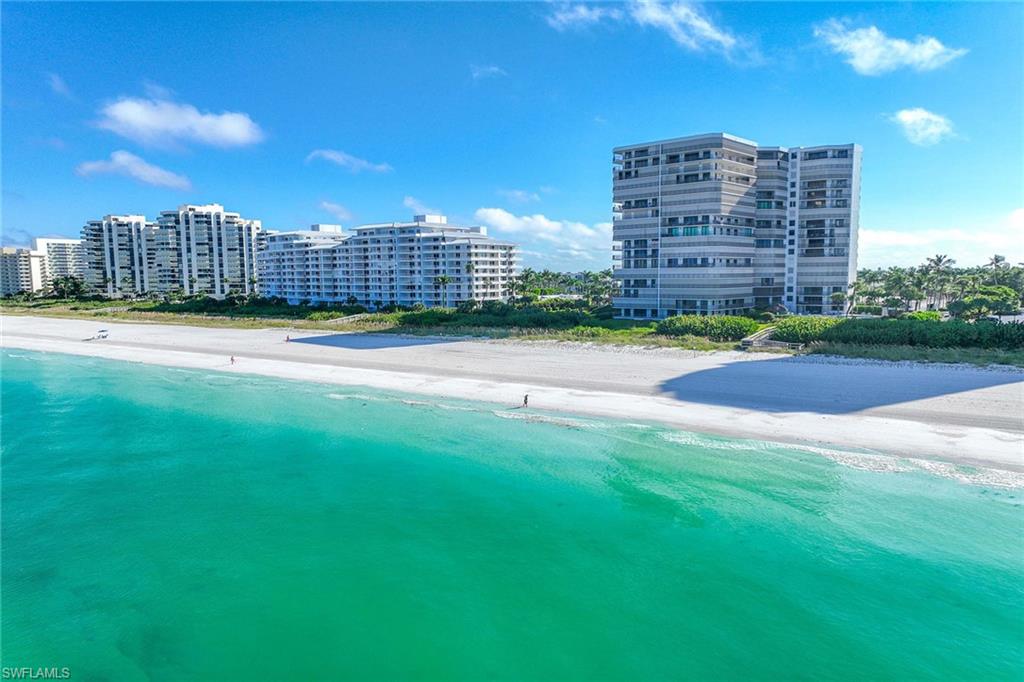 840 South Collier Boulevard, Unit 1104 Marco Island, FL 34145 - Photo 45 of 50 a view of a building with a big yard and a large building in the back