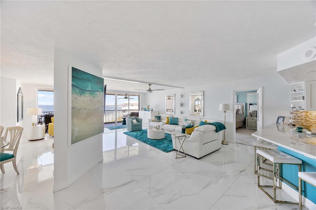 840 South Collier Boulevard, Unit 1104 Marco Island, FL 34145 - Photo 10 of 50 a living room with furniture and a table