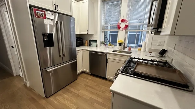 a kitchen with a refrigerator and a sink
