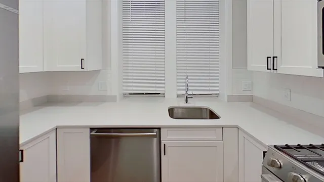 a kitchen with a sink and a stove