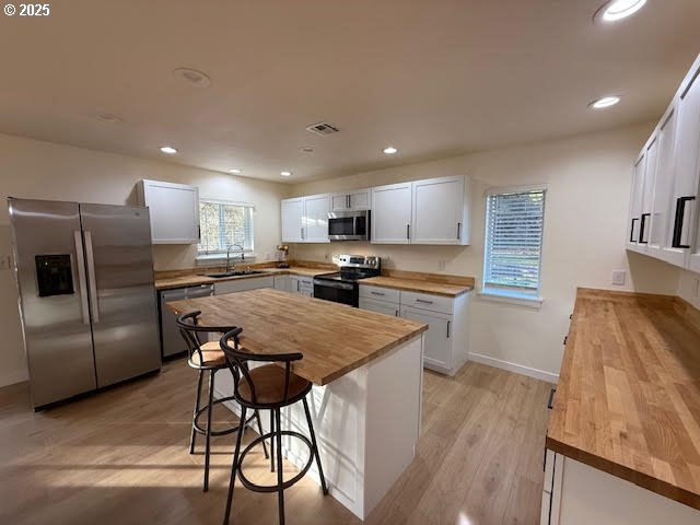 575 Cedar Street Sutherlin, OR 97479 - Photo 13 of 47 a kitchen with stainless steel appliances granite countertop a refrigerator a sink a stove a microwave a dining table and chairs with wooden floor