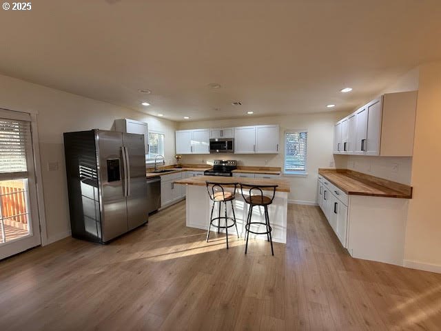 575 Cedar Street Sutherlin, OR 97479 - Photo 10 of 47 a kitchen with stainless steel appliances kitchen island granite countertop a stove top oven a sink a refrigerator and white cabinets