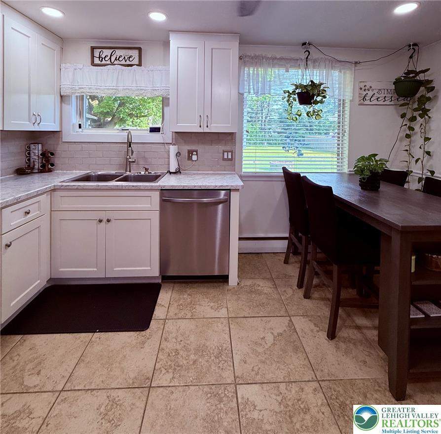 1275 Macada Road Bethlehem, PA 18017 - Photo 30 of 87 Bright, naturally illuminated kitchen featuring white cabinetry and durable tile flooring, perfect for daily living.