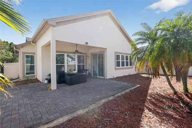 a view of a house with backyard and trees