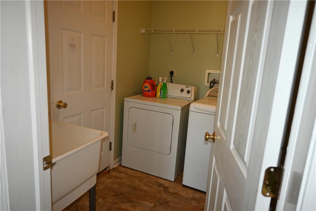 3829 East Hopewell Road Center Valley, PA 18034 - Photo 17 of 52 Functional laundry space featuring durable flooring and convenient overhead shelving.
