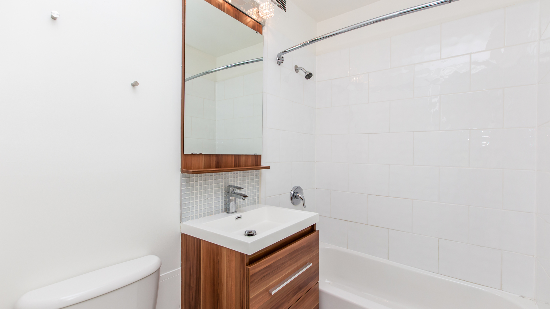 Undisclosed Address Chicago, IL 60611 - Photo 13 of 18 a bathroom with a sink a toilet and shower